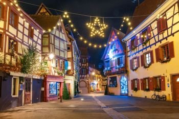 Traditional Alsatian half-timbered houses in old town of Colmar, decorated and illuminated at christmas time, Alsace, France. Christmas street in Colmar, France