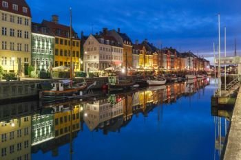 Nyhavn with colorful facades of old houses and old ships in the Old Town of Copenhagen, capital of Denmark.. Nyhavn in Copenhagen, Denmark.