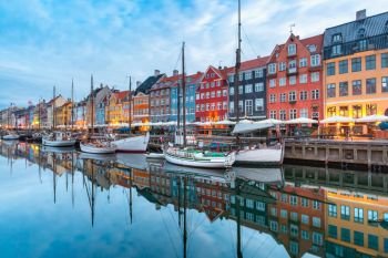 Nyhavn with colorful facades of old houses and old ships in the Old Town of Copenhagen, capital of Denmark.. Nyhavn in Copenhagen, Denmark.