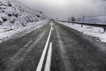 Snowy mountain road in winter, cold detail, road trip. Snowy mountain road in winter