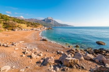 Beautiful view of the sandy beach and the rocky coast of the Black Sea, the landscape of the Crimea