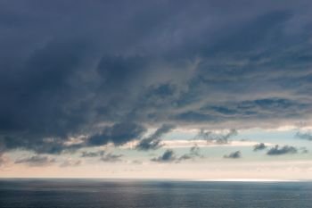 Heavy blue clouds over the sea dramatic seascape