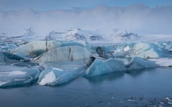 Panoramic view of the glacier lagoon Joekulsarlon with icebergs and in the background the glacier, winter in Iceland, Europe
