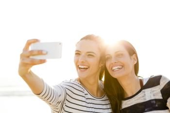 Two best friends taking a selfie with cellphone