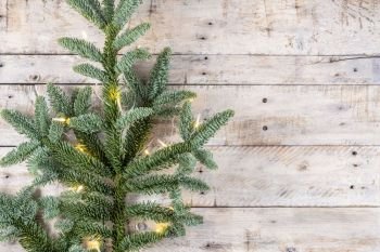 Christmas theme background in vintage tone. Rustic wood background for Christmas with copy space for all Christmas design. Old wood texture decorated with Christmas decoration theme for wallpaper and product. Pine branch. Top view. Flat layer
