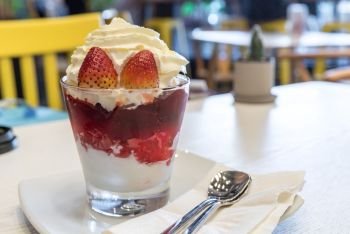 Strawberry Parfait, Healthy layered dessert with cream, muesli and fresh strawberry sauce 