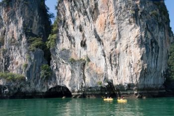 Tourists in inflatble canoes exploring Koh Hong, hang Nga Bay, huket, Thailand