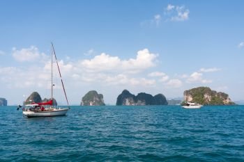 Yacht and power boat with limestone islands, Phang Nga Bay, Phuket, Thailand
