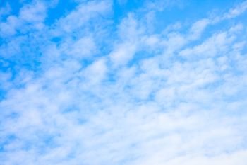 Pale blue sky with clouds - abstract background, space for text
