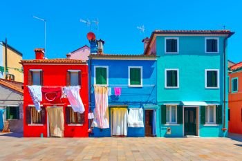 Street with colorful houses in Burano, Venice, Italy                             