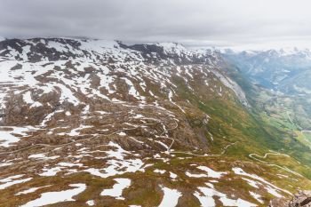 Tourism vacation and travel. Fantastic view from the Dalsnibba Plateau viewpoint on Geirangerfjord and mountains landscape with road winding through hills, Norway Scandinavia.. View on Geirangerfjord from Dalsnibba viewpoint in Norway