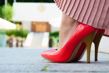 Fashion and footwear. Red high heel classic shoes outdoor during sunny day.. Red high heel classic shoes outdoor