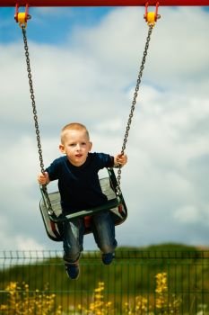 Child boy sitting on swing