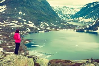 Tourism holidays and travel. Woman tourist standing near Djupvatnet lake, relaxing meditation with serene mountains view, Stranda More og Romsdal, Norway Scandinavia.. Tourist woman standing by Djupvatnet lake, Norway