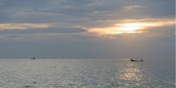 View of fishing boat on the ocean at sunset, Zihuatanejo, Guerrero, Mexico