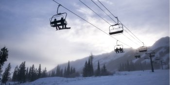 Tourists on ski lifts in valley,  Kicking Horse Mountain Resort, Golden, British Columbia, Canada