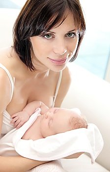 Happy young mother holding a baby