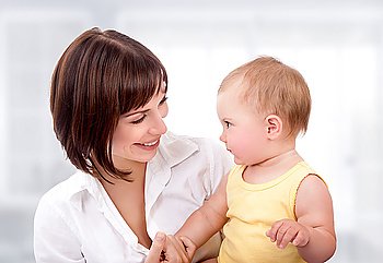 Portrait of beautiful mother  with cute adorable little daughter at home, happy young family, love and happiness concept