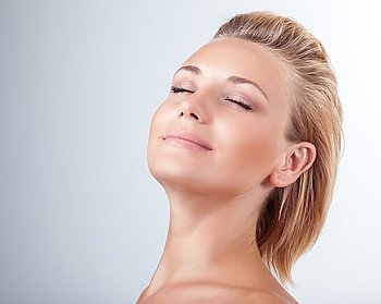 Satisfied woman at spa, portrait of beautiful female with closed eyes of pleasure over light background, natural cosmetics, enjoying day at spa salon