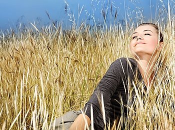 Woman enjoying on the wheat field, nature at autumn, natural landscape background, female outdoor