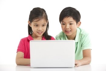 Studio Shot Of Two Chinese Children With Laptop