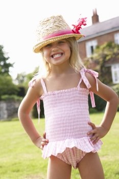 Portrait Of Young Girl Standing In Garden Wearing Swimming Costume