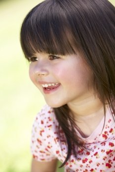 Outdoor Portrait Of Smiling Young Girl