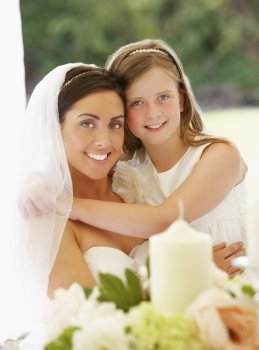 Portrait Of Bride With Bridesmaid In Marquee At Reception