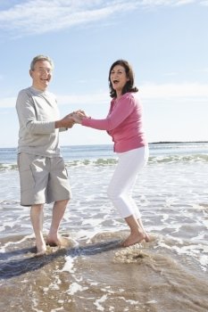 Senior Couple Having Fun On Beach Holiday
