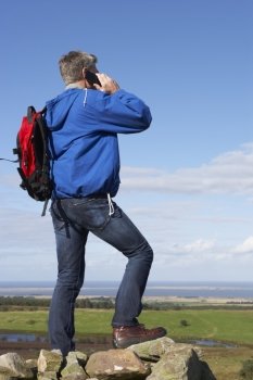 Man Using Mobile Phone In Remote Countryside