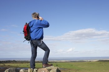 Man Using Mobile Phone In Remote Countryside