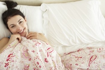 Woman Relaxing In Bed