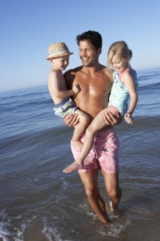Father And Children Having Fun On Beach