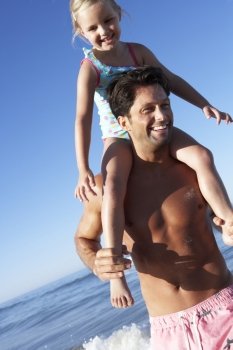 Father And Daughter Having Fun On Beach