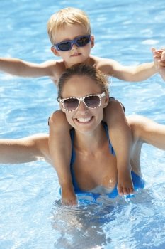 Mother And Son Having Fun In Swimming Pool