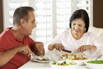 Senior Couple Enjoying Meal At Home