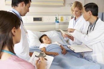 Medical Team Visiting Child Patient On Ward Round