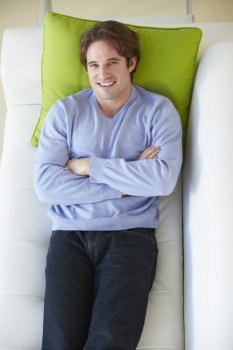 Overhead View Of Man Relaxing On Sofa