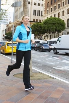 Woman Running Along Urban Street