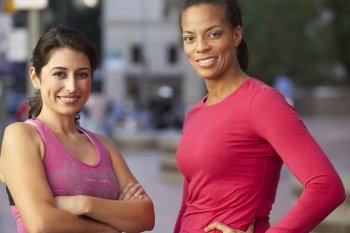 Portrait Of Two Female Runners On Urban Street