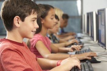 Elementary Students Working At Computers In Classroom