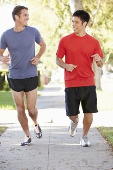 Two Male Runners Exercising On Suburban Street