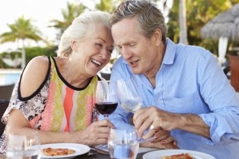Senior Couple Enjoying Meal In Outdoor Restaurant