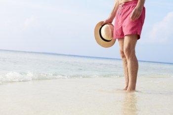 Detail Of Senior Man Standing In Sea On Beach Holiday