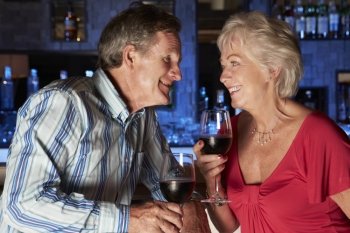 Senior Couple Enjoying Drink In Bar