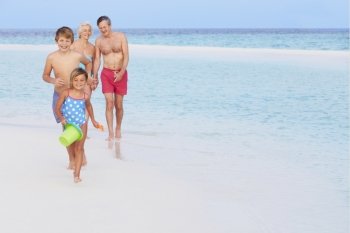 Grandparents And Grandchildren Having Fun On Beach Holiday