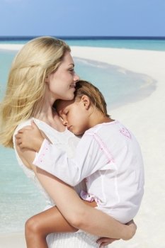 Mother And Daughter Hugging On Beautiful Beach