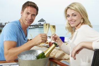 Couple Enjoying Meal In Seafront Restaurant