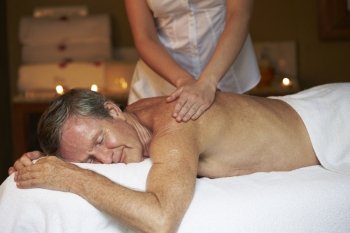 Senior Man Having Massage In Spa