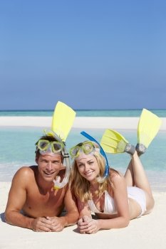 Couple With Snorkels Enjoying Beach Holiday